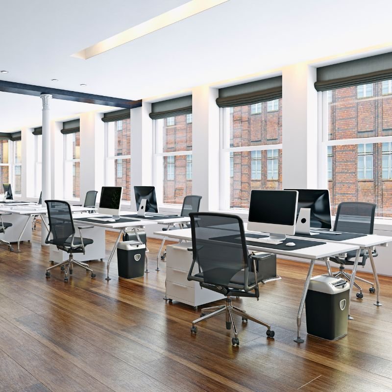 Open office space with desks and computers.